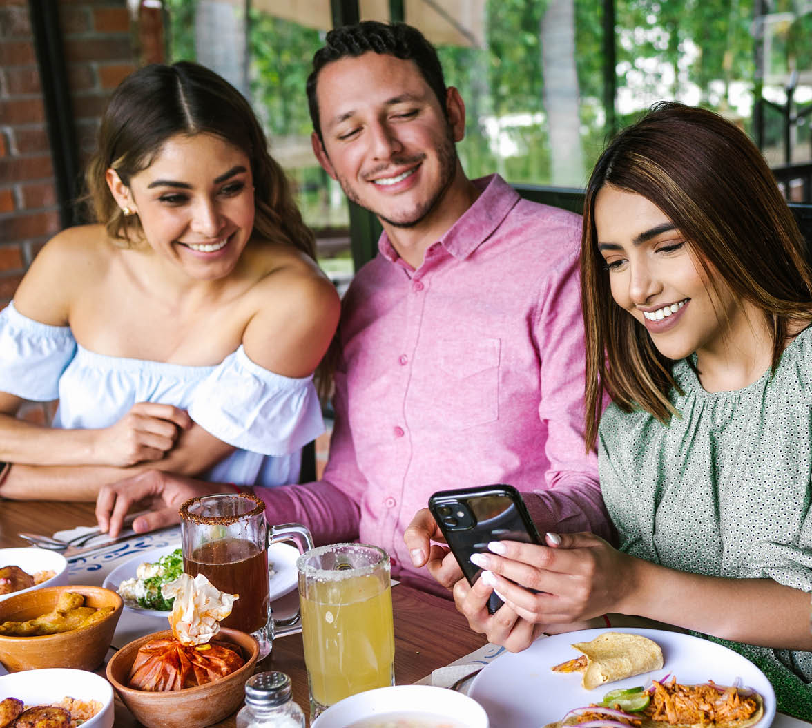 Group of latin friends eating mexican food in the restaurant terrace in Mexico Latin America