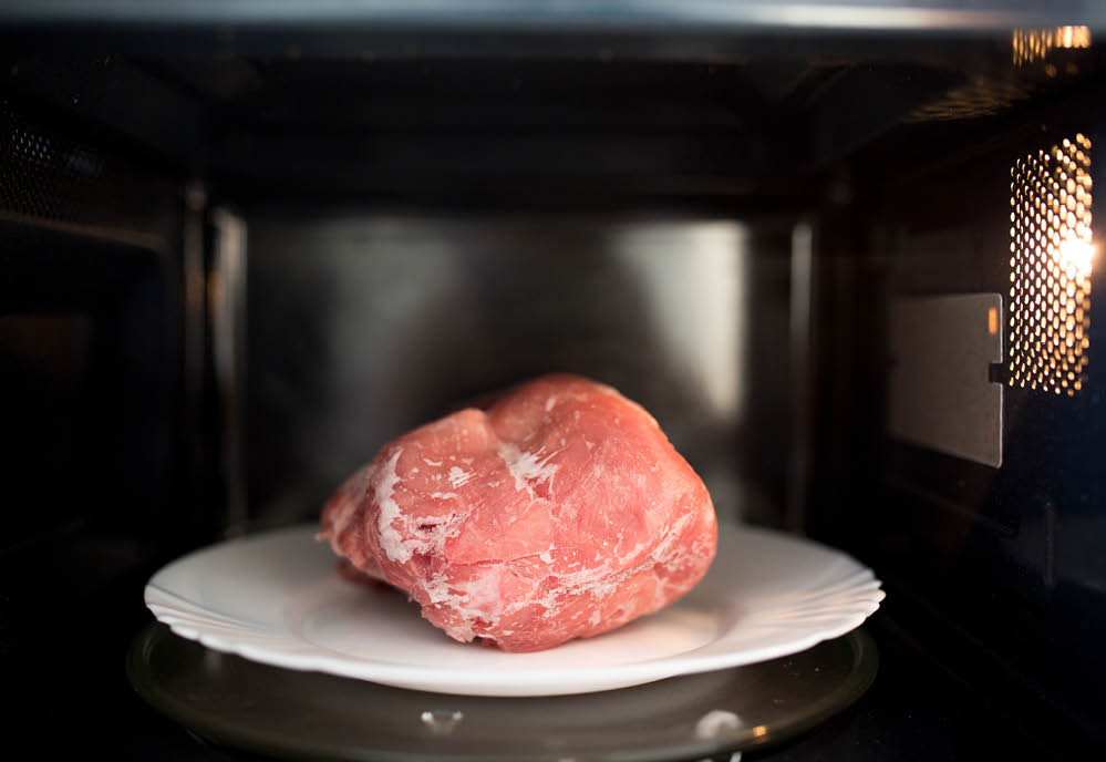 Frozen pork defrosted in the microwave